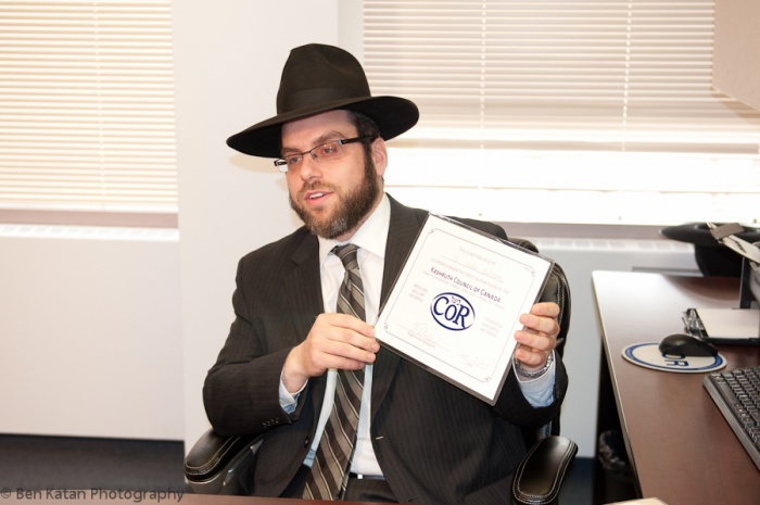 Rabbi Tsvi Heber Holding A Cor Establishment Certificate Title Image
